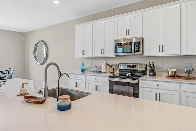 kitchen featuring white cabinetry, appliances with stainless steel finishes, and sink