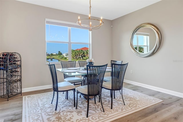 dining area with a chandelier and hardwood / wood-style flooring