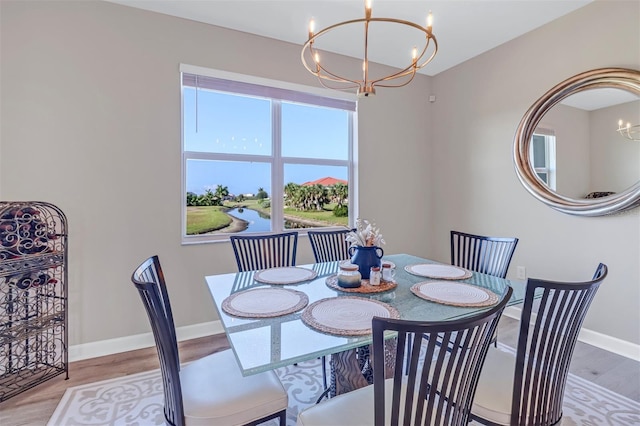 dining room with a notable chandelier and light hardwood / wood-style flooring