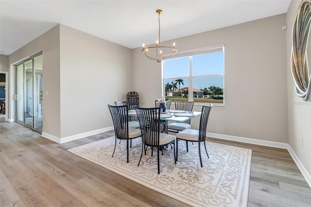 dining room featuring a notable chandelier and light hardwood / wood-style floors