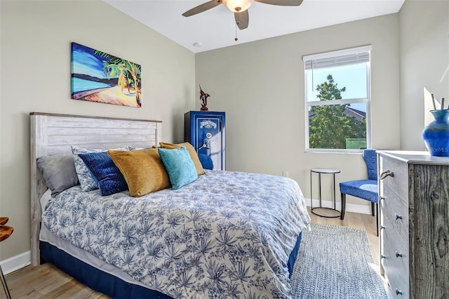 bedroom with ceiling fan and light hardwood / wood-style floors