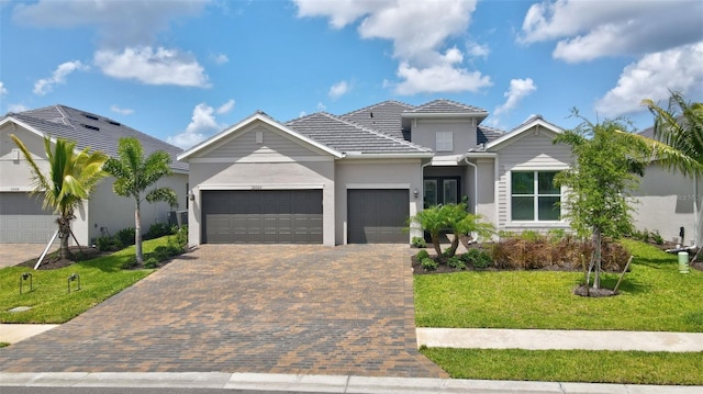 view of front of home featuring a garage and a front lawn