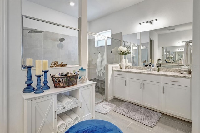 bathroom featuring vanity and an enclosed shower