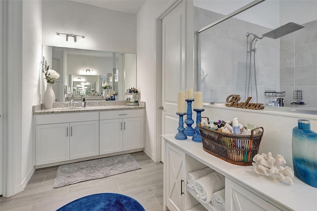 bathroom featuring vanity and tiled shower