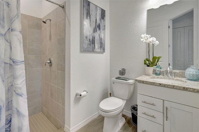 bathroom with vanity, toilet, and walk in shower