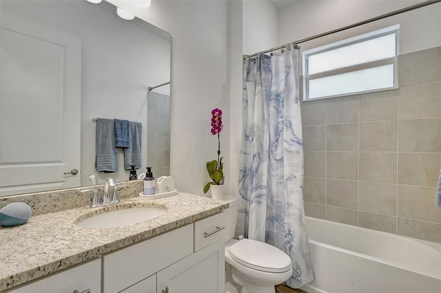 full bathroom featuring shower / tub combo with curtain, vanity, and toilet