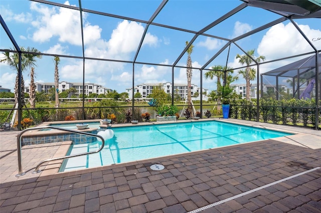 view of pool with an in ground hot tub, glass enclosure, and a patio