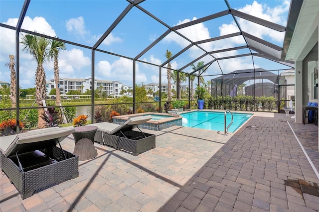 view of pool with an in ground hot tub, a lanai, and a patio