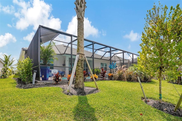 view of playground with a yard and glass enclosure