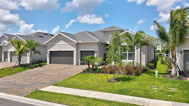 view of front of home featuring a garage and a front lawn