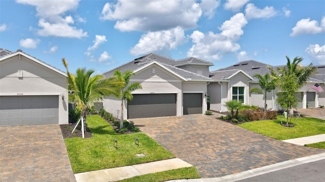 view of front of property featuring a garage and a front lawn