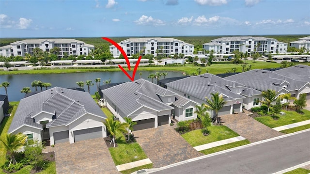 birds eye view of property with a water view