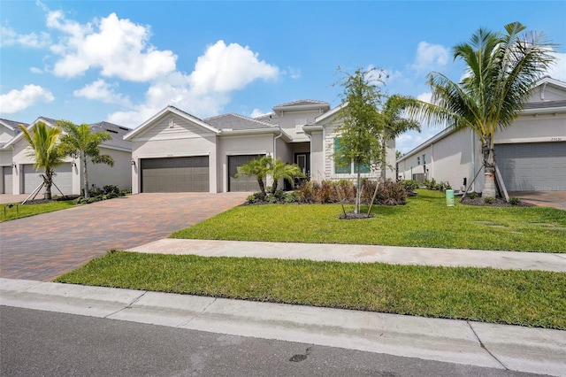 view of front of property with a garage and a front lawn