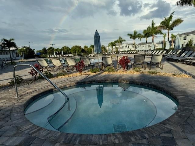 view of pool with a hot tub