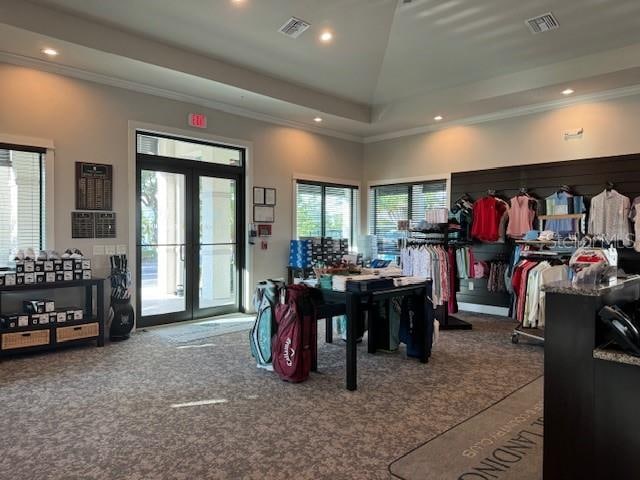 interior space with high vaulted ceiling, carpet, a tray ceiling, crown molding, and french doors