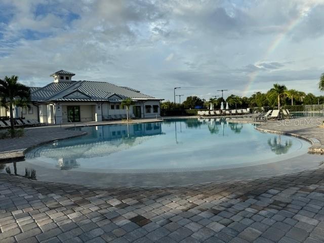 view of swimming pool with a patio area