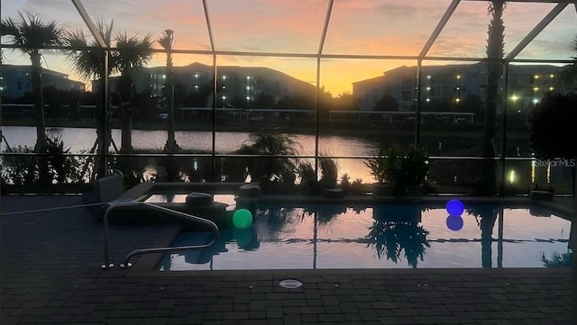 pool at dusk with glass enclosure