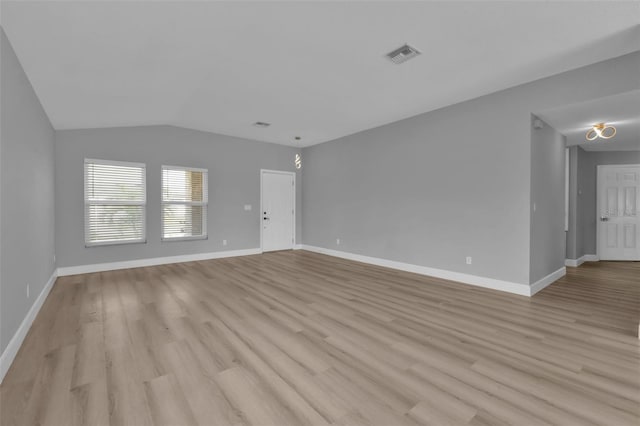 unfurnished living room featuring light wood-style floors, visible vents, and baseboards