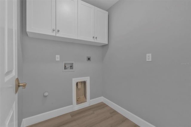 washroom featuring light wood-style flooring, washer hookup, baseboards, cabinet space, and electric dryer hookup