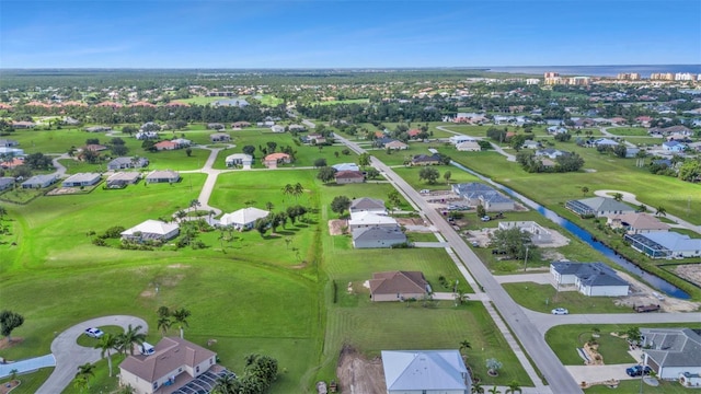 birds eye view of property featuring a water view and a residential view