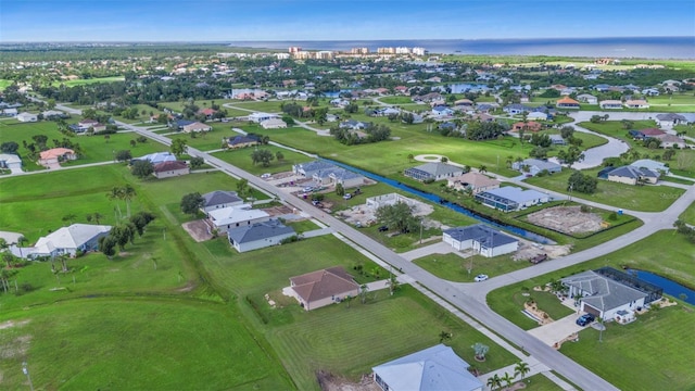 drone / aerial view with a water view and a residential view