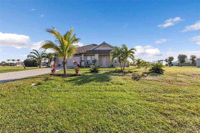 ranch-style home with a garage and a front lawn