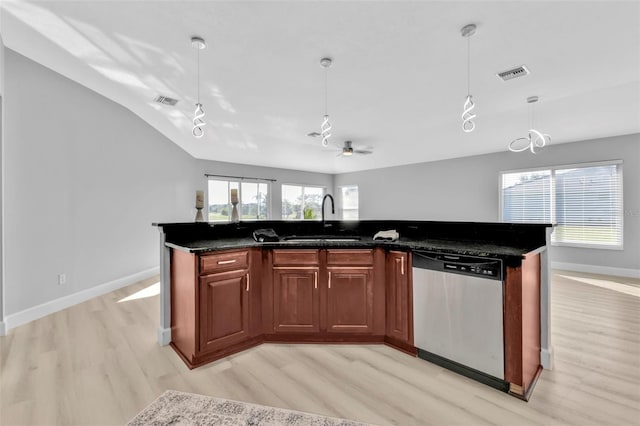 kitchen featuring stainless steel dishwasher, light wood-type flooring, a sink, and visible vents