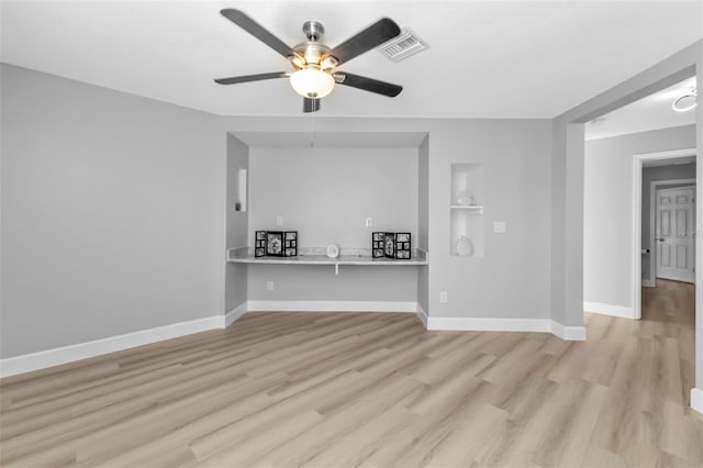 unfurnished living room featuring light wood-style floors, baseboards, visible vents, and ceiling fan