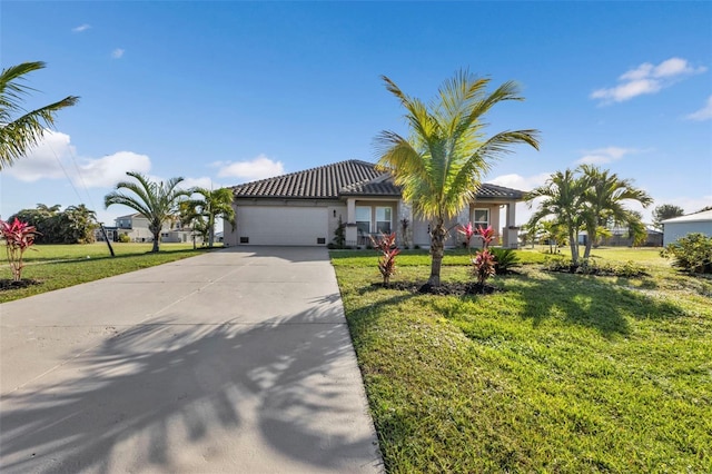 view of front of house with a garage, driveway, a front yard, and stucco siding