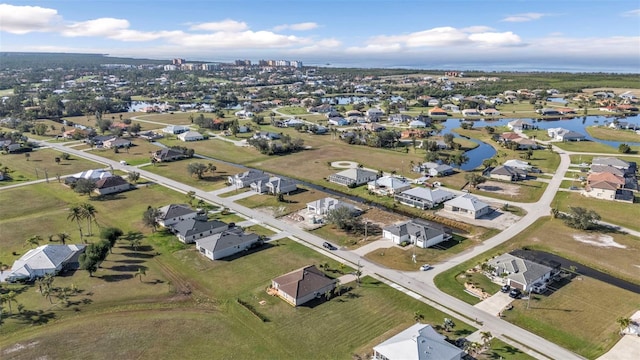 birds eye view of property featuring a water view and a residential view