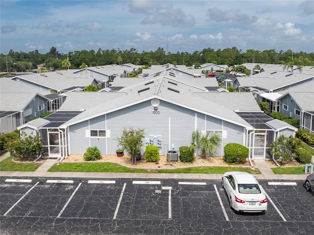 view of building exterior featuring a residential view and uncovered parking