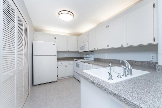 kitchen featuring sink, white cabinets, and white appliances