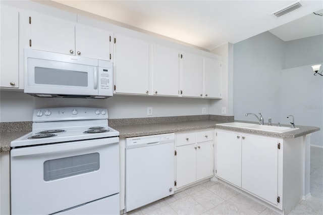 kitchen with white cabinets, white appliances, light tile patterned floors, and kitchen peninsula