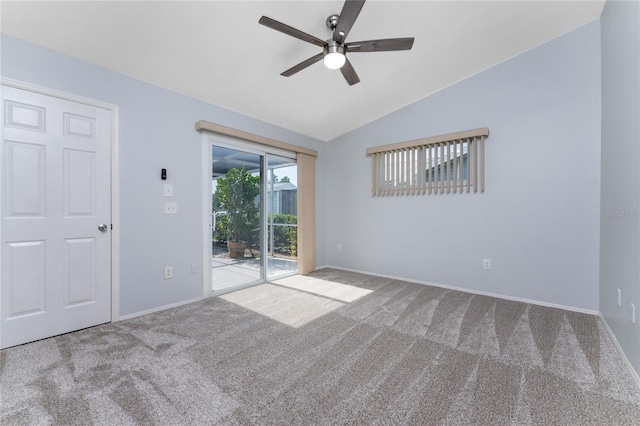 spare room featuring carpet, ceiling fan, and vaulted ceiling