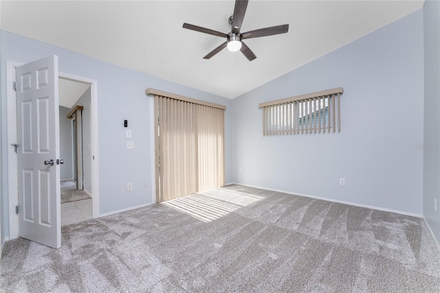 unfurnished bedroom featuring light colored carpet, ceiling fan, and vaulted ceiling