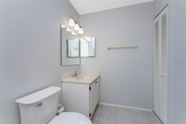 bathroom featuring vanity, tile patterned flooring, and toilet