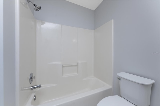 bathroom featuring bathing tub / shower combination and toilet