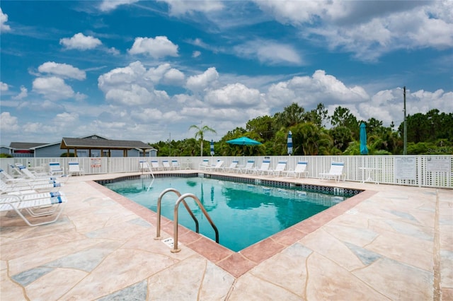 view of swimming pool featuring a patio area