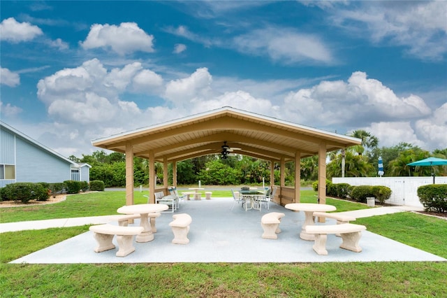 view of property's community featuring a lawn and a patio area