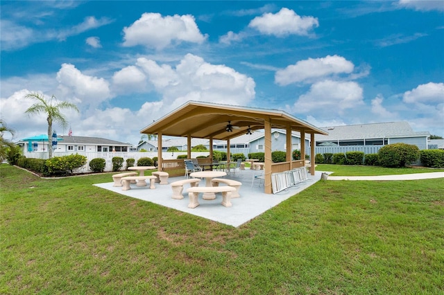 view of community with a yard and a patio area