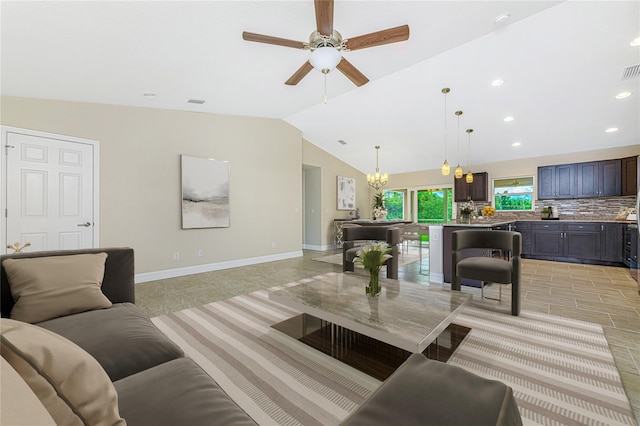 living room featuring ceiling fan with notable chandelier, light tile patterned floors, and vaulted ceiling