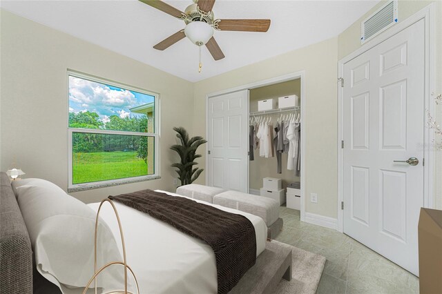 tiled bedroom featuring a closet and ceiling fan