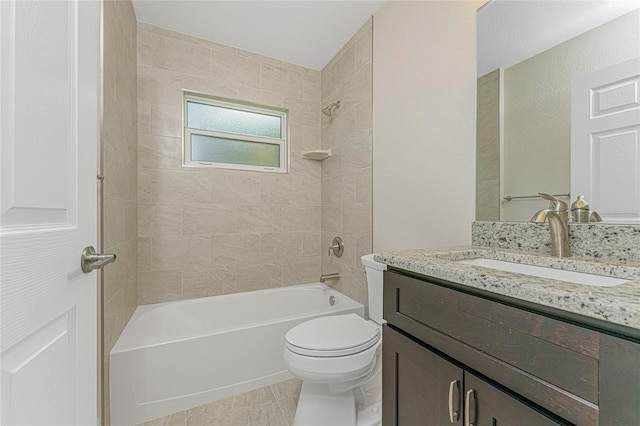 full bathroom with vanity, tiled shower / bath, tile patterned flooring, and toilet