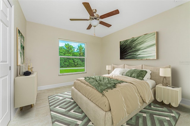 bedroom featuring ceiling fan and tile patterned floors