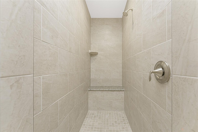 bathroom with a tile shower