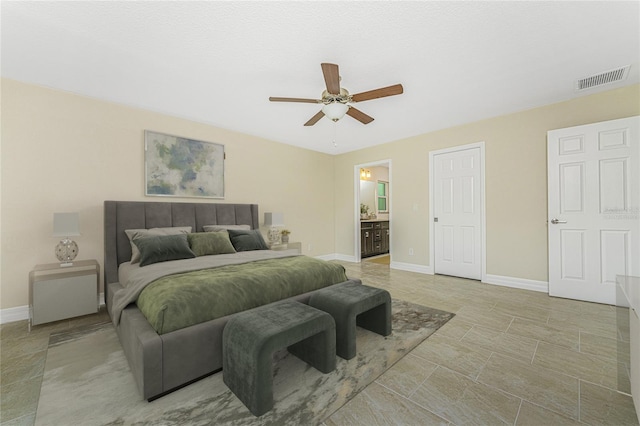 bedroom featuring light tile patterned flooring, connected bathroom, and ceiling fan