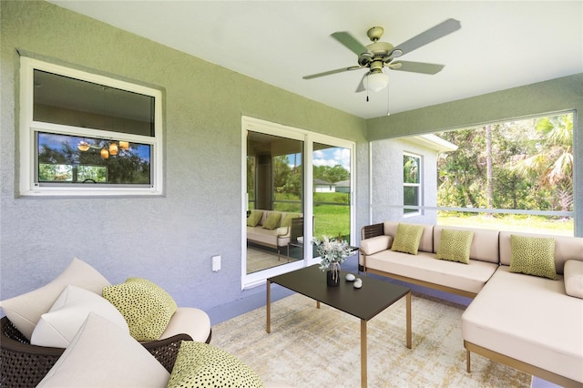 sunroom / solarium featuring ceiling fan and a wealth of natural light