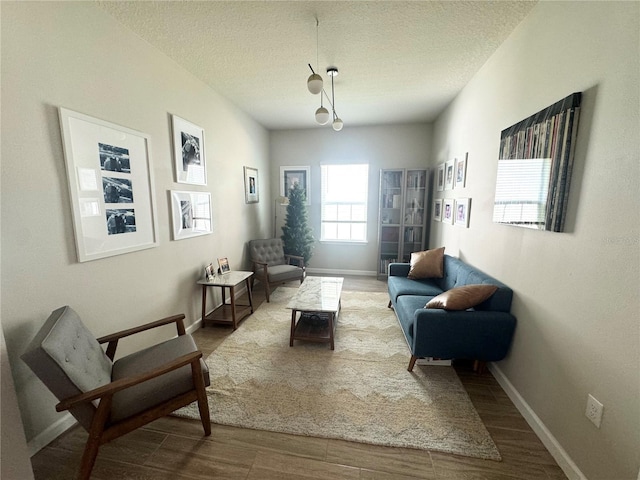 living area with hardwood / wood-style flooring and a textured ceiling