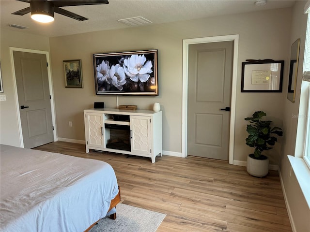 bedroom featuring light hardwood / wood-style flooring and ceiling fan