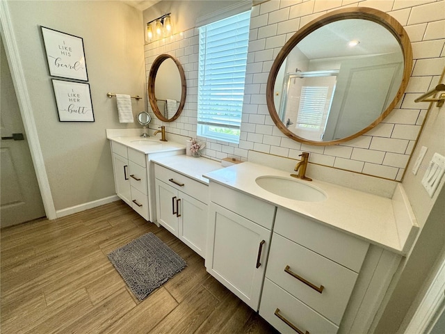 bathroom featuring tasteful backsplash, vanity, and hardwood / wood-style floors